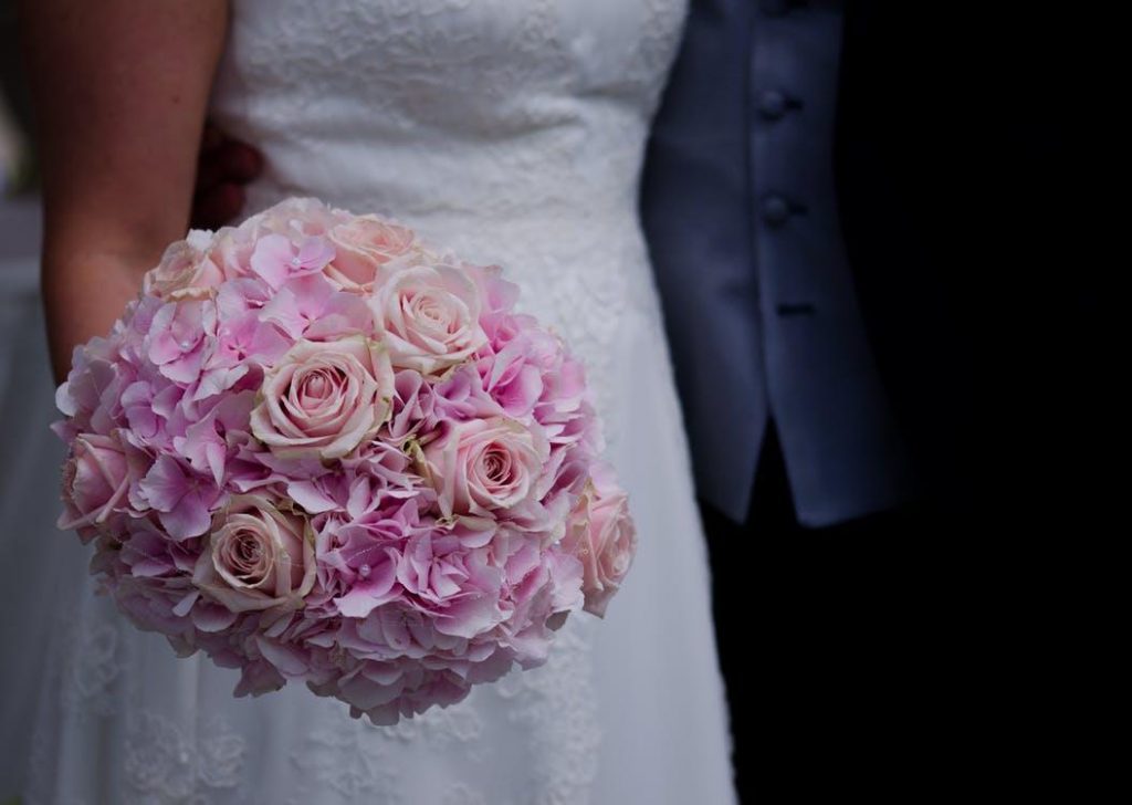  a bride holding a bridal bouquet