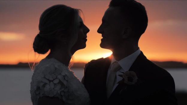 A shot from Hope and Tyler's wedding and engagement photos of them looking at one another in front of the sunset by one of the best wedding photographers in Maryland